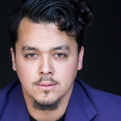 headshot of Latino man Terence Mejos with short slick hair and relaxed white collared shirt